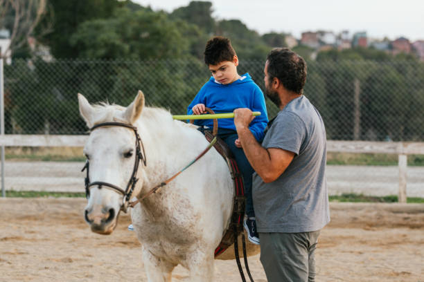 istock young man with disability riding a horse assisted by an instructor 1459608586