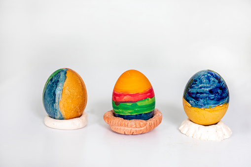 three striped easter eggs on a white background, preparation for the holiday