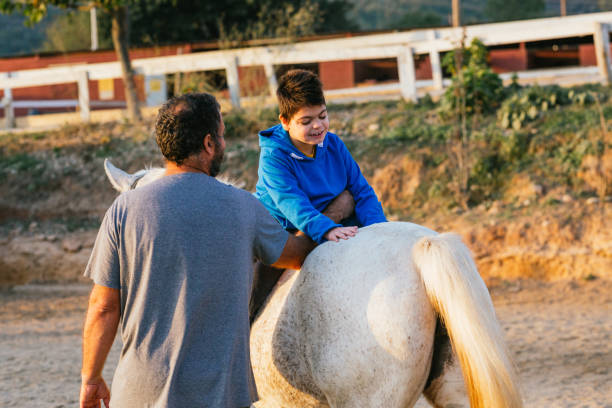 istock boy with disability strengthening his upper body with equine therapy exercises 1459609634