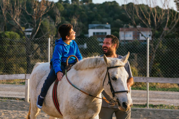 istock Child with cerebral palsy receiving equine therapy 1459609844