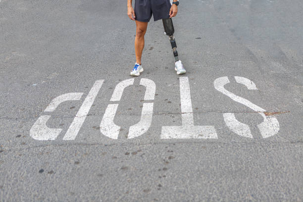 istock Crop amputee standing near Stop inscription 1459610246
