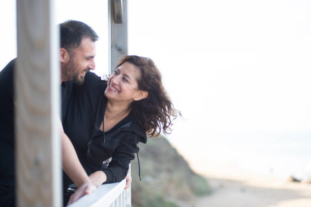 istock Happy couple watching view from balcony 1459611161