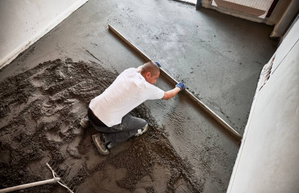 istock Man screeding floor in apartment during renovation. 1459612794