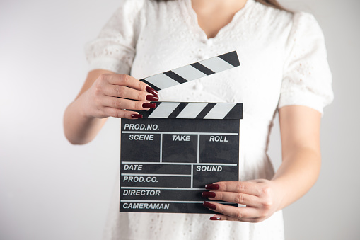 Hands is holding black Clapperboard or movie slate. it use in video production ,film, cinema industry on white background.