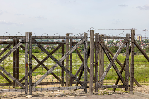 Majdanek; Lublin; Poland - May 25, 2022: Majdanek concentration and extermination camp, view on barbed wire fence. It was a Nazi camp built and operated by the SS during the German occupation of Poland in World War II