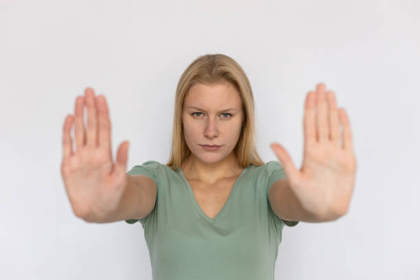 istock Angry young woman showing stop sign 1459620347