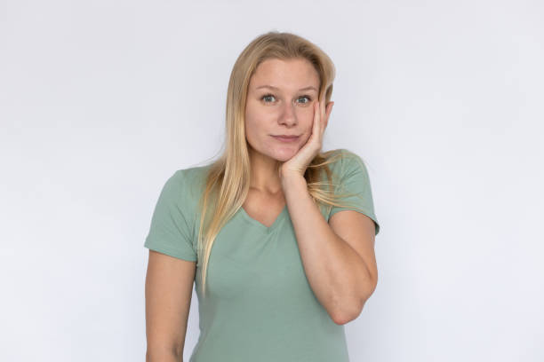 istock Shocked woman with hand on cheek 1459621598