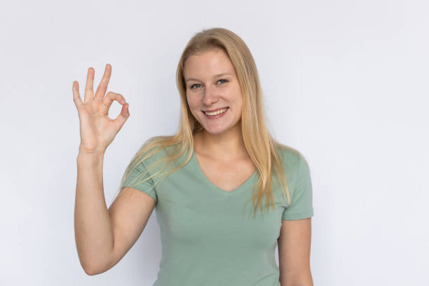 istock Happy woman showing ok gesture 1459625204