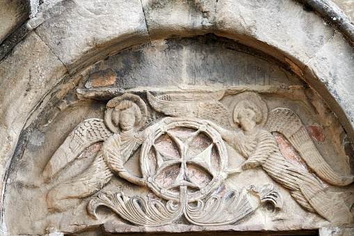 Mtskheta, Georgia. Close View Of Bas-Relief Glorification Of The Cross Crowning The Entrance To The Ancient Jvari Monastery, Georgian Orthodox Church Of Holly Cross, World Heritage By Unesco.