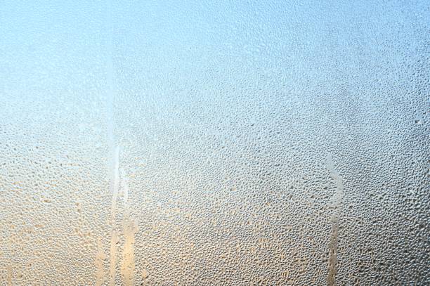 condensation on the window glass. large drops - condensation steam window glass imagens e fotografias de stock