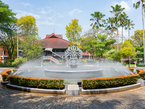 Depok, West Java, Indonesia - August 12, 2022: Large landscape view of the Fountain Garden at the Faculty of Business and Economics, the University of Indonesia.