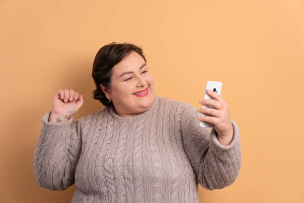 istock fun woman raising arms and celebrating 1459631089