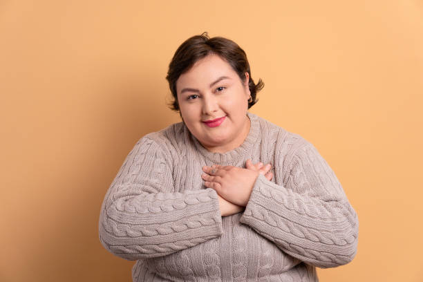 istock woman hands over heart, chest 1459631676