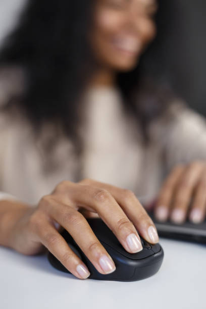 femme poc cliquant avec la souris d’ordinateur sans fil en gros plan, mise au point sur la main - souris dordinateur photos et images de collection