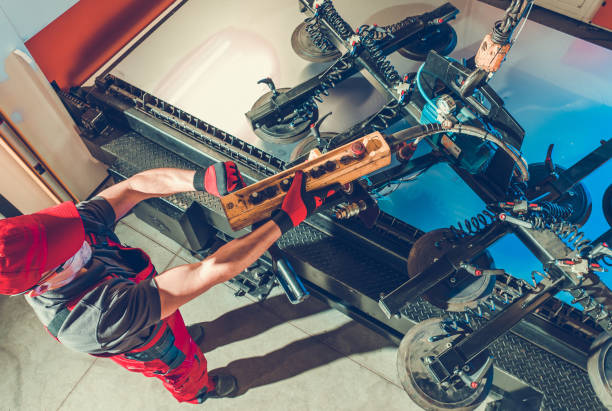 istock Metalworking Industry Worker Using Vacuum Lifting Device To Move Sheet of Metal 1459634095