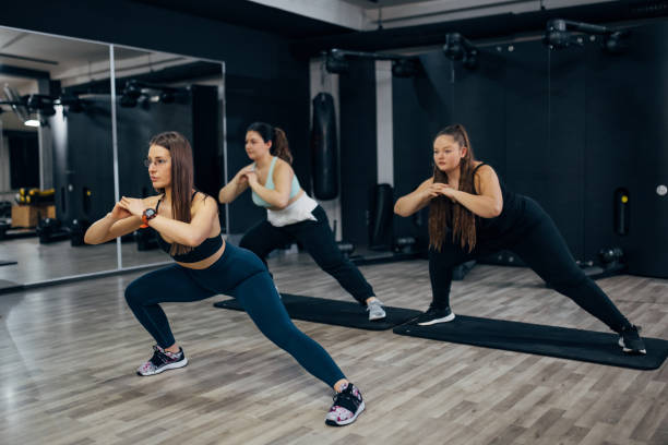 istock A personal trainer motivates her clients during personal training in the gym 1459635501