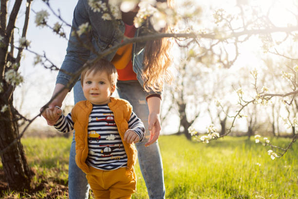 istock Mom and son in a blooming orchard in spring 1459639598