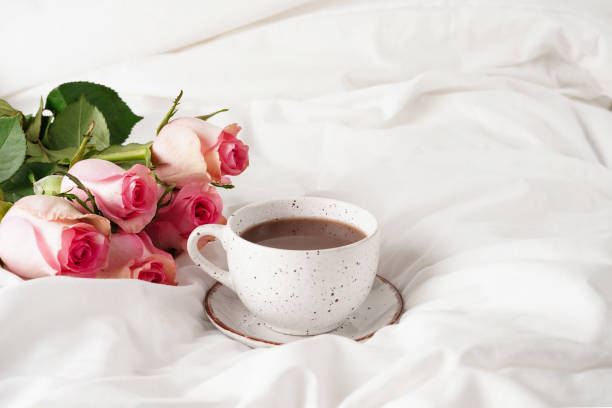 istock Morning breakfast in bed with coffee cup and pink roses flowers 1459648421