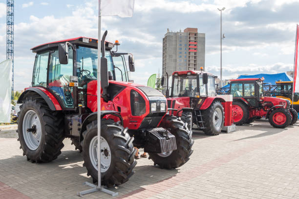 istock Three red wheeled tractors at an agricultural fair 1459650919