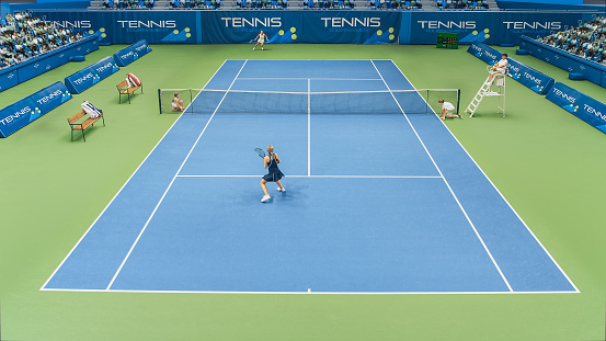 An overhead view of a male tennis player dress in white shirt and red shorts, holding up a racket in mid action, about to strike the ball in a volley during a tennis match. The player is playing on a blue/green tennis court appearing as abstract shapes from above.