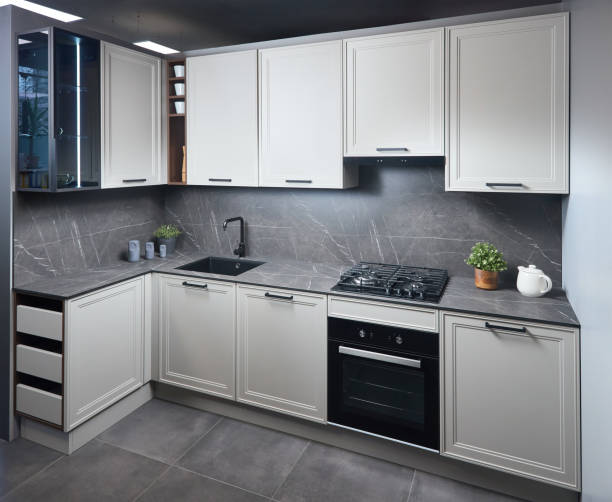 istock Interior of white and grey kitchen, horizontal, linear layout. Luxury modern fitted flat design kitchen with glass elements. 1459655296