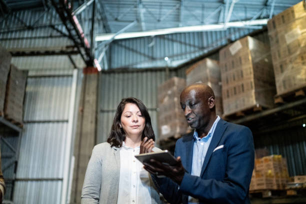istock Coworkers talking in a warehouse 1459657899
