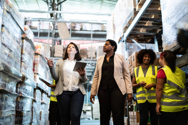 istock Coworkers talking while walking in a warehouse 1459658264