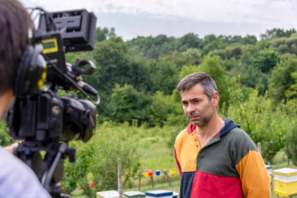 istock A female journalist interviews a beekeeper for a TV channel. 1459658617
