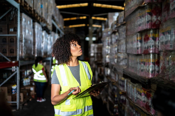 istock Young woman in the clipboard in a warehouse 1459659486