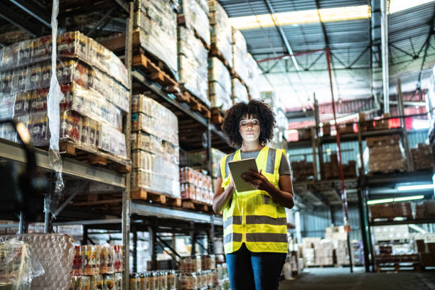 istock Young woman using the digital tablet in a warehouse 1459659515