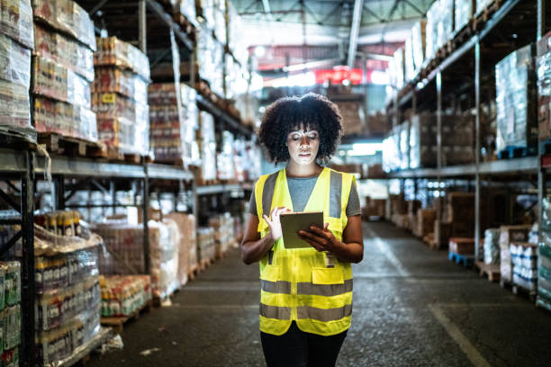 istock Young woman using the digital tablet in a warehouse 1459660658