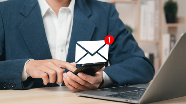 istock Businessman using smartphone and touching email icon with notification. Online communication concept. 1459660965