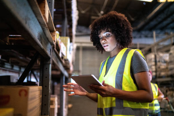 istock Young woman using the digital tablet in a warehouse 1459660969