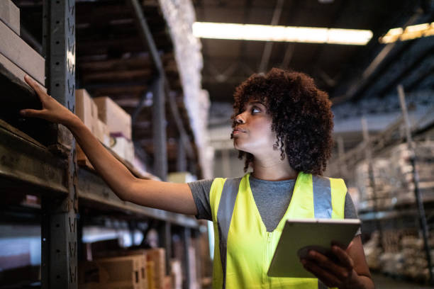 istock Young woman using the digital tablet in a warehouse 1459661205