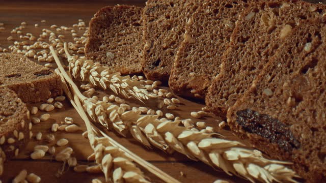 Grain rye bread slices around ears of wheat