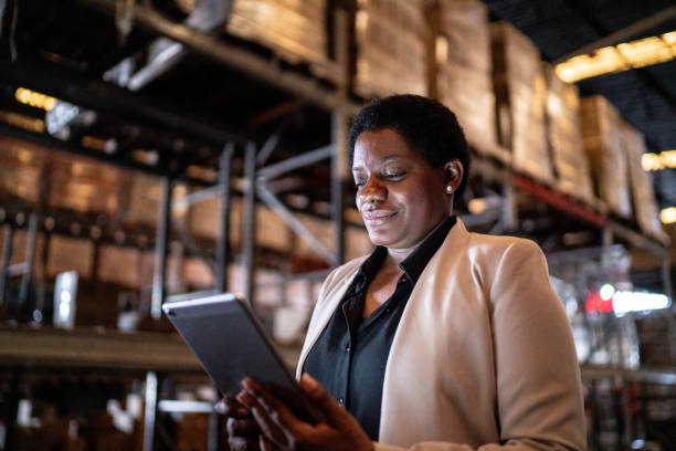 istock Mature woman using a digital tablet in a warehouse 1459661702