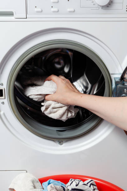 istock Hands take out the washed clothes from the washing machine 1459663073