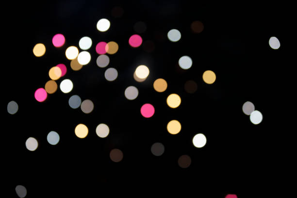 istock On a black background bokeh from explosions of colorful fireworks. 1459666724