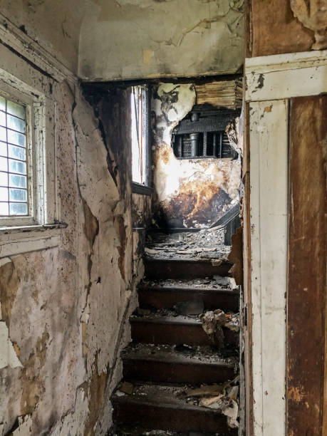 Stairs Inside Abandoned Home Stairs filled with dirt and debris lead upstairs inside an abandoned house in Highland Park. highland park michigan stock pictures, royalty-free photos & images