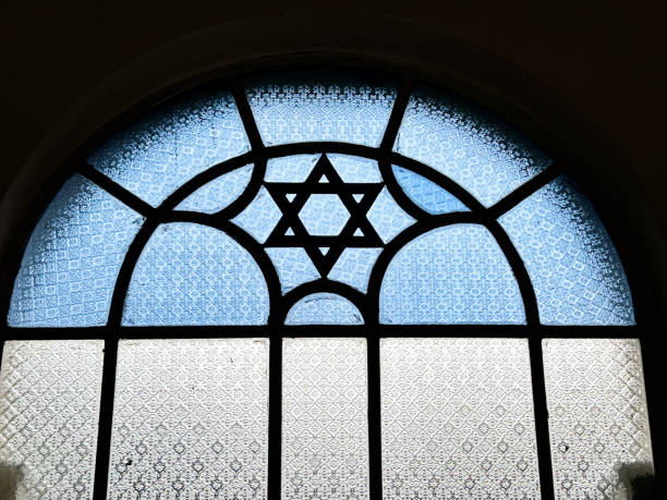 Stained Glass Window With Star Of David A stained glass window in a Singapore synagogue features a Star of David in blue and white glass as an architectural feature. synagogue stock pictures, royalty-free photos & images