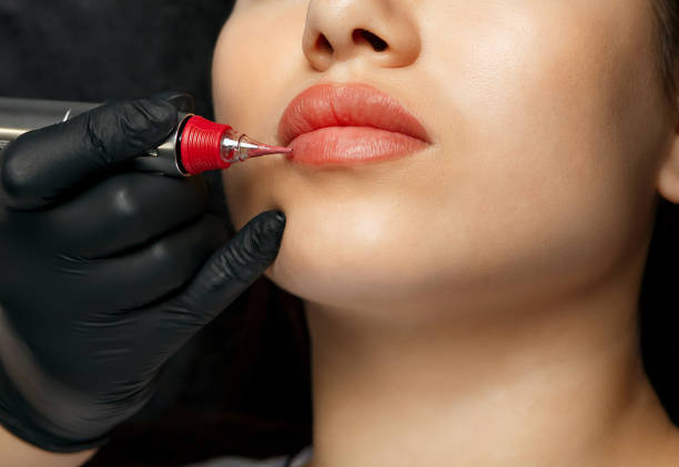 istock Cosmetician in gloves applying permanent makeup 1459673178