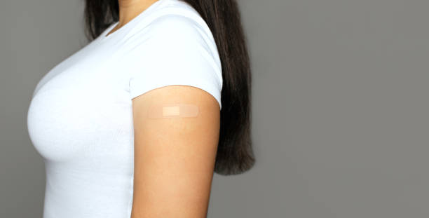 istock Woman with a plaster on her hand after vaccination 1459673267