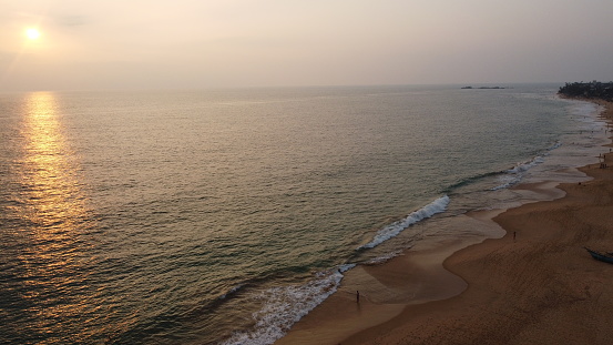 Aerial Footage from a drone capturing the blue water of Indian ocean with clear sky. Surfing spots, coral reefs and stunning sunsets