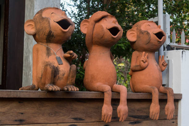 Three Cute, Silly, Terracotta Monkey Statues with Mouths Open.