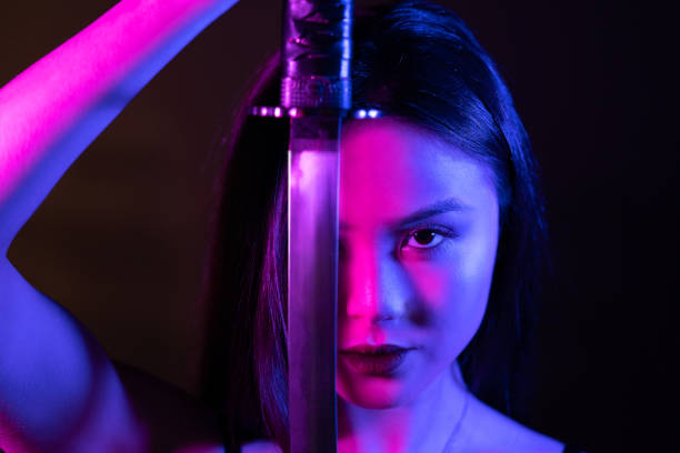 Neon lights. Beautiful asian woman with katana sword.