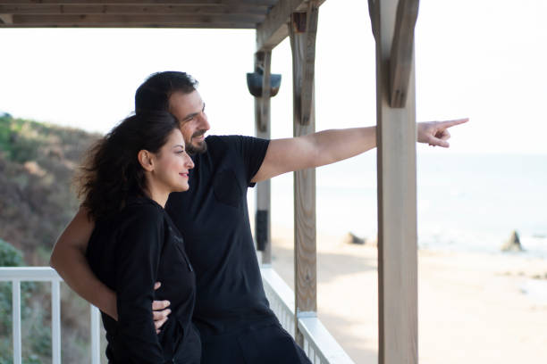 istock Happy couple watching view from balcony 1459678966