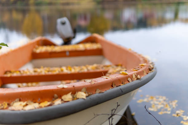 Two canoes and colorful autumn leaves by the river. Selective focus.