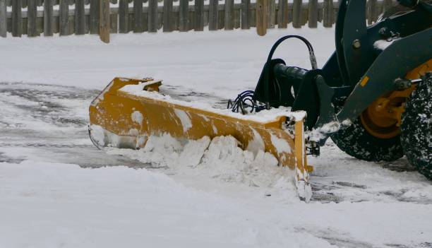 istock ARTICULATED TRACTOR - SNOW PLOW PUSHING SNOW WITH BLADE 1459682034