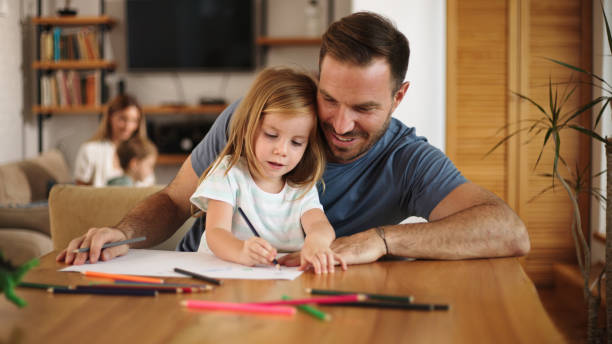 istock Father and daughter having good time drawing at home together 1459687892