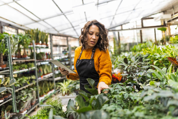 istock Woman working at garden center checking inventory 1459690887